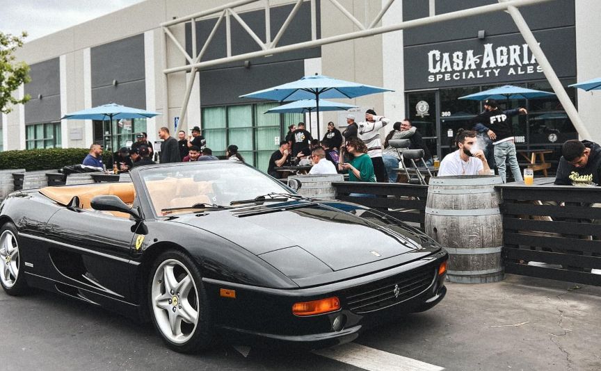 Cars And Craft Instagram pic storefront and black Ferrari