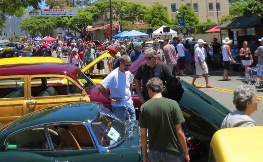 Rods And Roses crowded street pic with banner in background